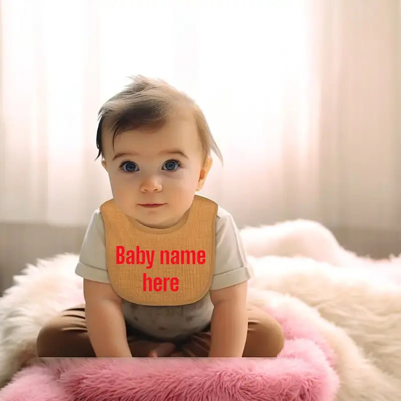 baby wearing cute personalised bib with name embroidered
