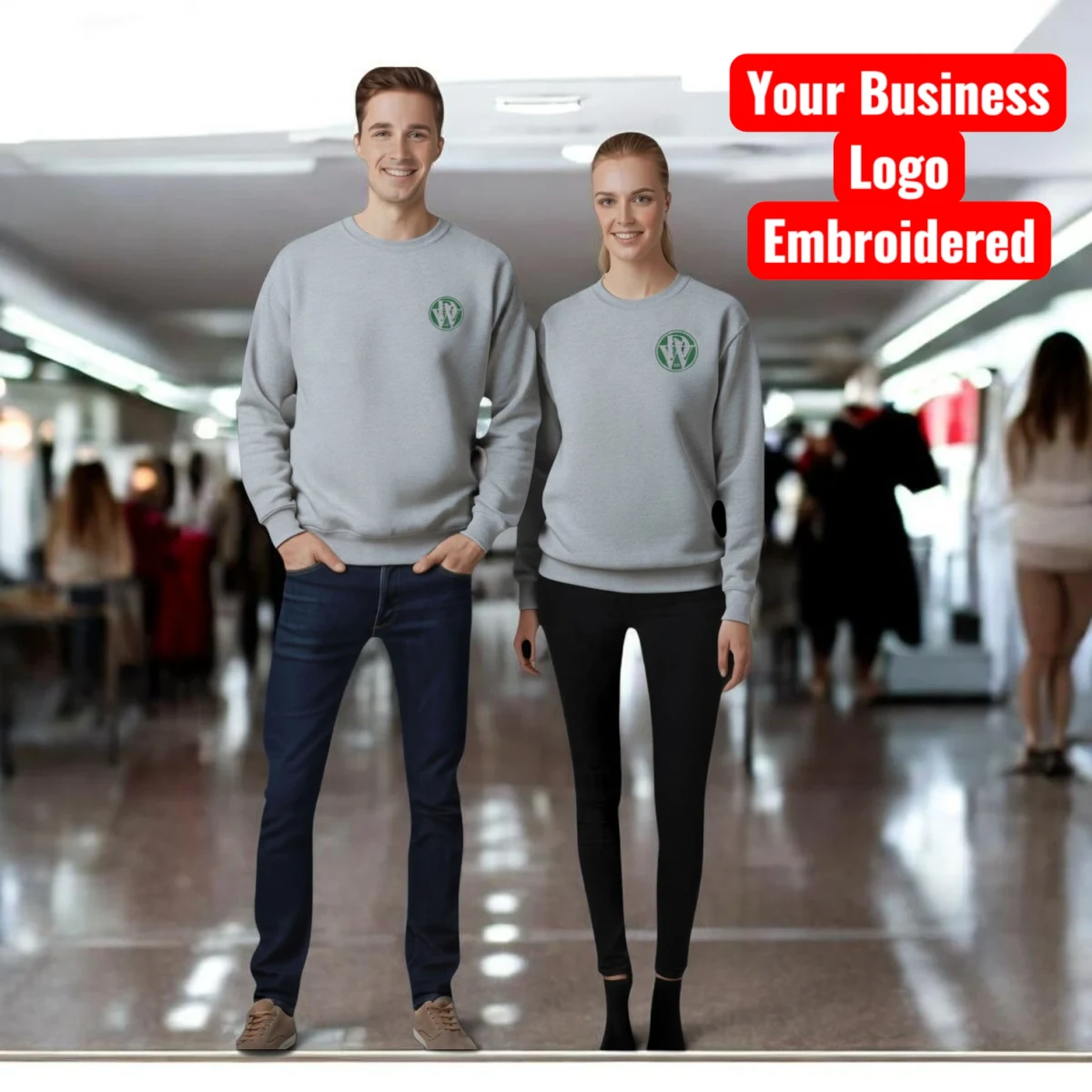 Two people wearing grey sweatshirts with a business logo embroidered on the left chest (example shown with the DoggiesWorld logo)