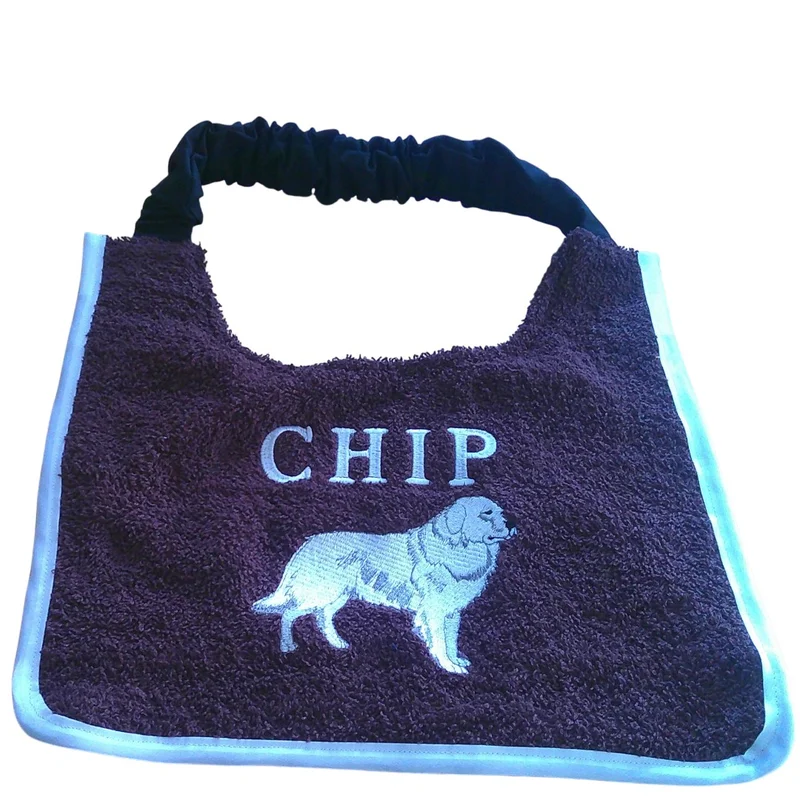 Wine towelling Pyrenean Mountain Dog bib embroidered with the name CHIP and a white Pyrenean dog