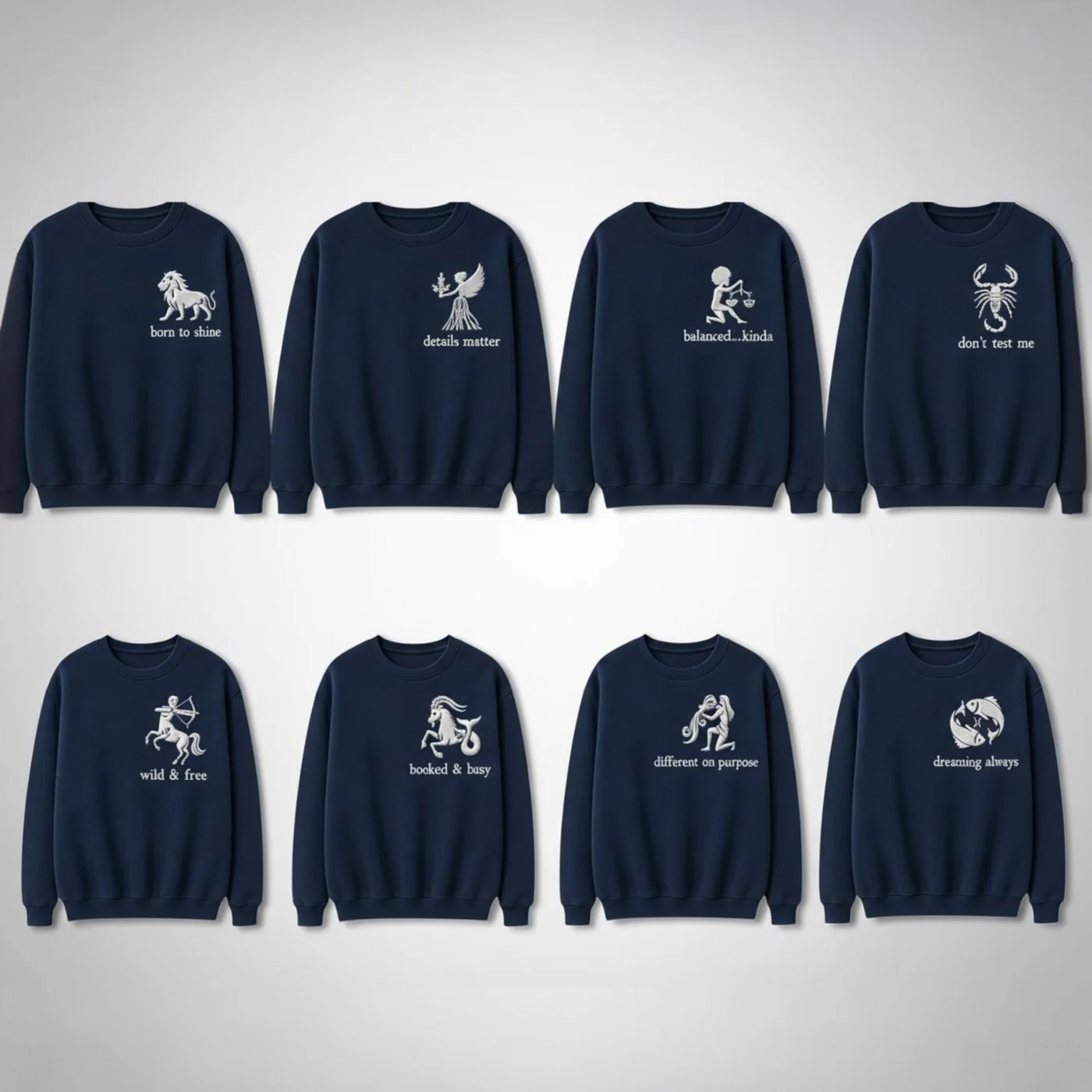 Eight zodiac sweatshirts in navy with white embroidery and each sign's wording